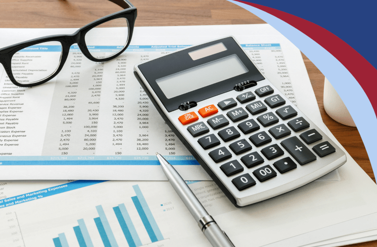 A pen and a calculator on top of a financial spreadsheet