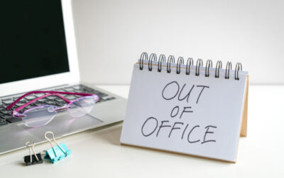 A desk with a sign reading "Out of Office"